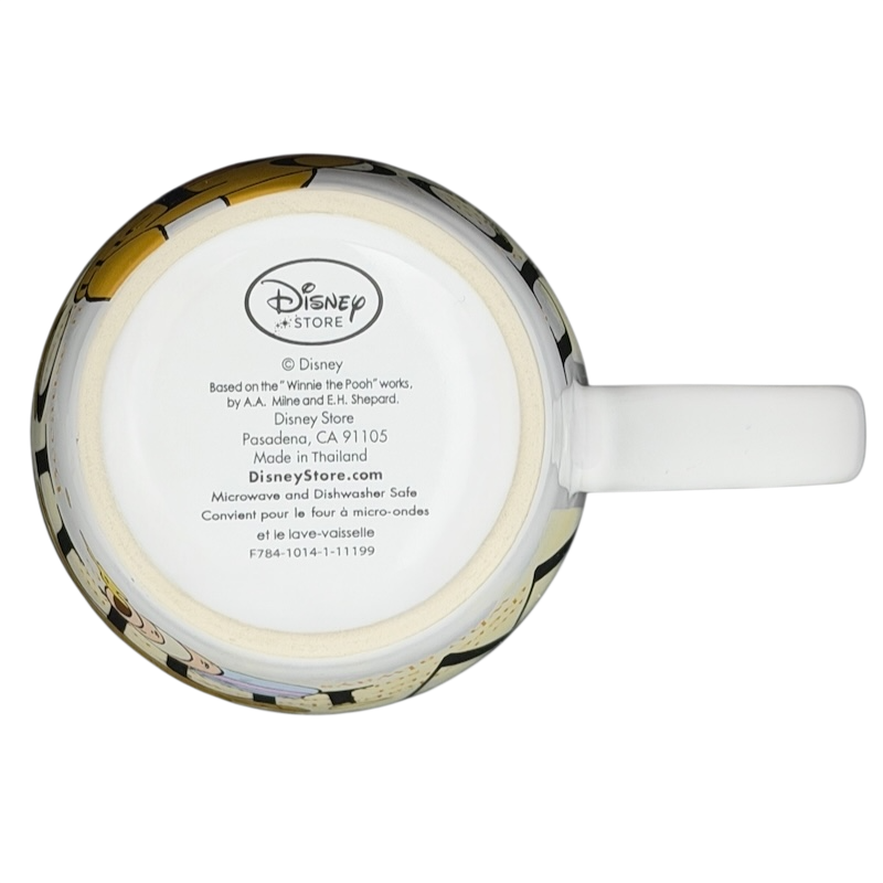 Top view of a Winnie the Pooh Storybook Mug Disney Store featuring classic illustrations and a white handle