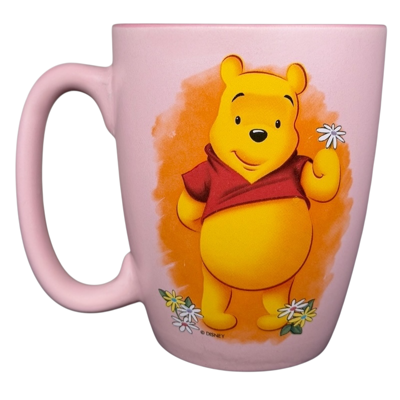 Disney Winnie the Pooh daisy pink mug featuring Pooh holding a daisy flower