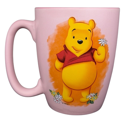 Disney Winnie the Pooh daisy pink mug featuring Pooh holding a daisy flower