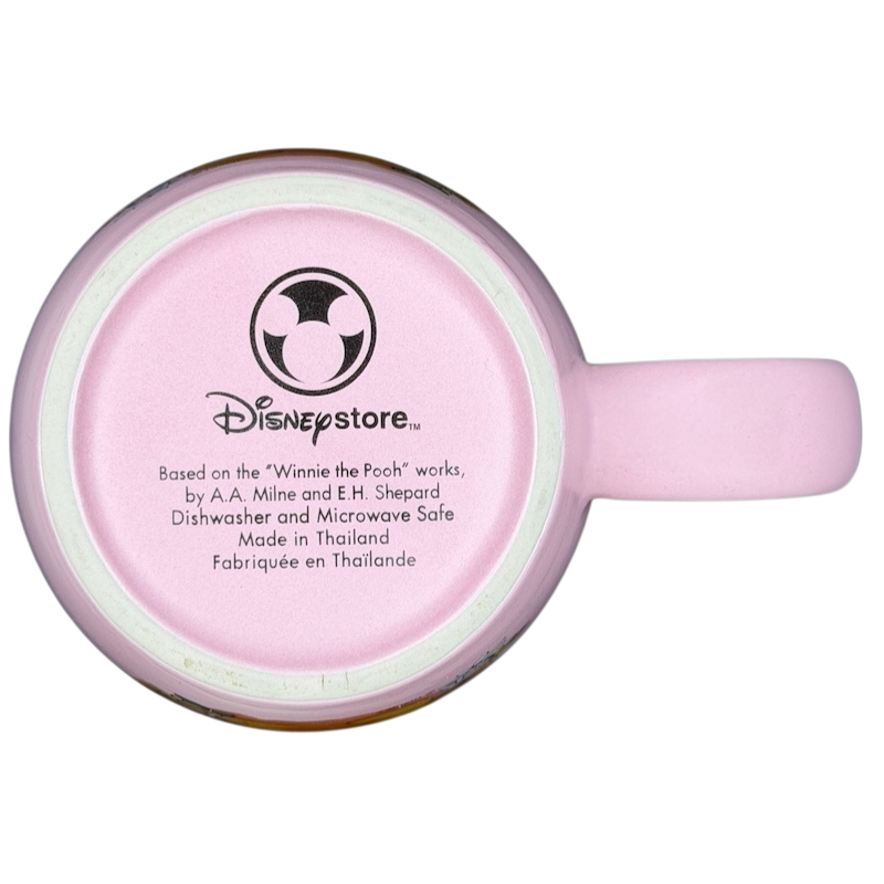Bottom view of a Disney Winnie the Pooh daisy pink mug showing branding and care instructions