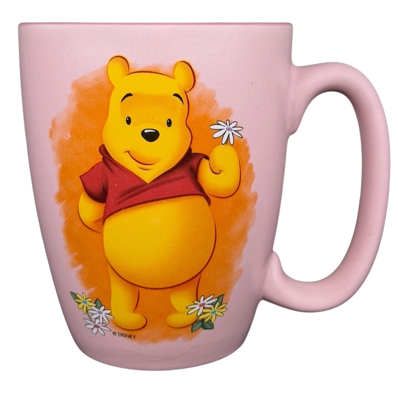 Disney Winnie the Pooh daisy pink mug featuring Pooh holding daisies with a pastel background