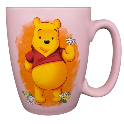 Disney Winnie the Pooh daisy pink mug featuring Pooh holding daisies with a pastel background