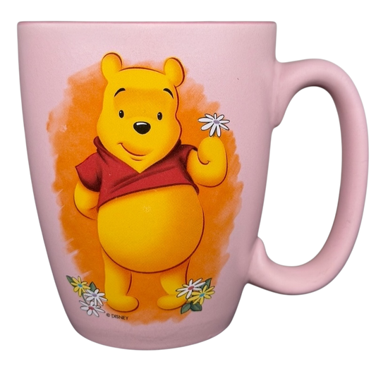 Disney Winnie the Pooh daisy pink mug featuring Pooh holding daisies with a pastel background