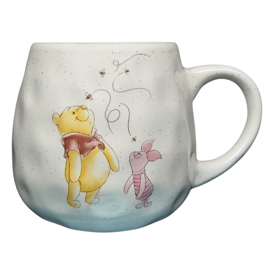 Winnie the Pooh dimpled ceramic collectible mug featuring Pooh and Piglet looking at bees on speckled white ceramic