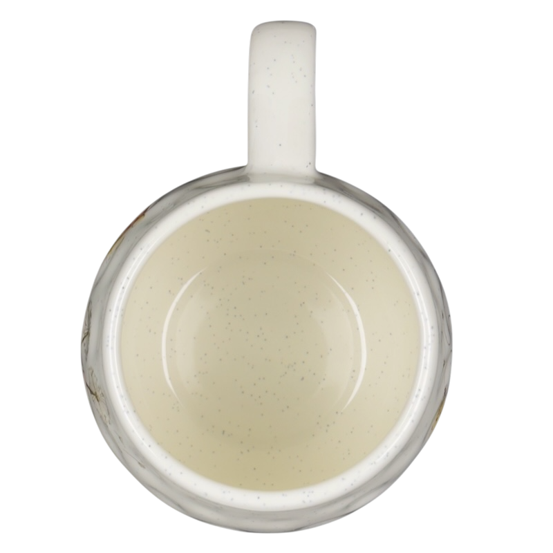 Top view of a speckled off white Winnie the Pooh dimpled ceramic collectible mug with handle