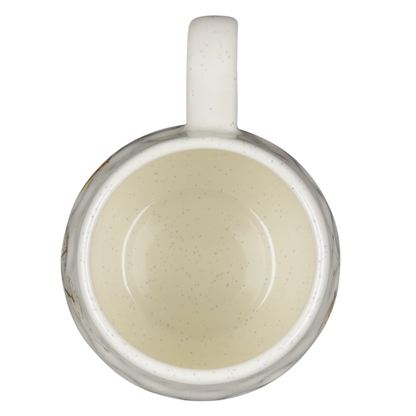 Top view of a speckled off white Winnie the Pooh dimpled ceramic collectible mug with handle