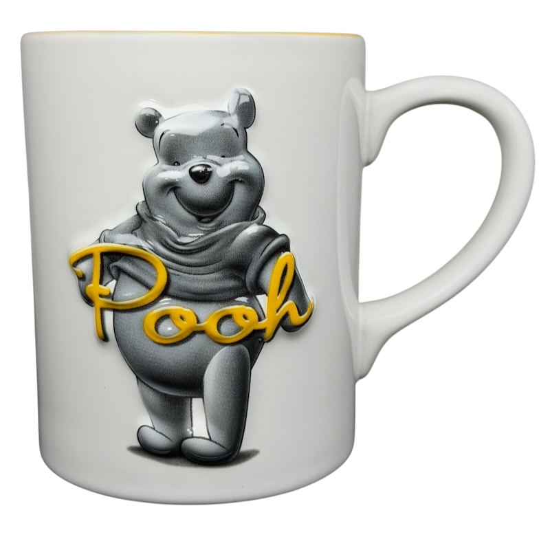 Winnie The Pooh Embossed Mug Disney featuring a cheerful Pooh design in gray and yellow