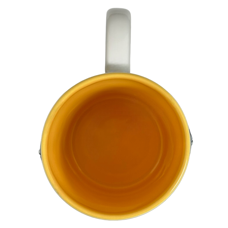 Top view of Winnie The Pooh Embossed Mug Disney with vibrant yellow interior and white handle