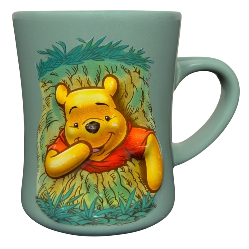 Disney ceramic mug featuring Winnie the Pooh stuck in tree vintage mug design on seafoam green background