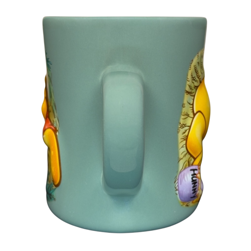 Winnie the Pooh stuck in tree vintage mug light teal ceramic mug back handle view showing Pooh and hunny pot