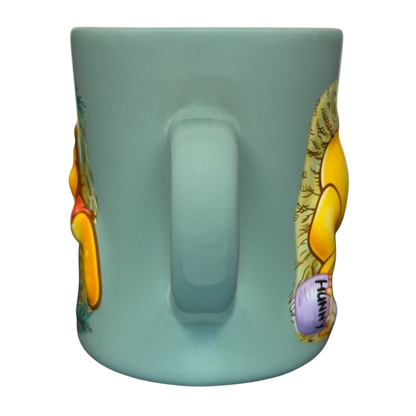 Winnie the Pooh stuck in tree vintage mug light teal ceramic mug back handle view showing Pooh and hunny pot