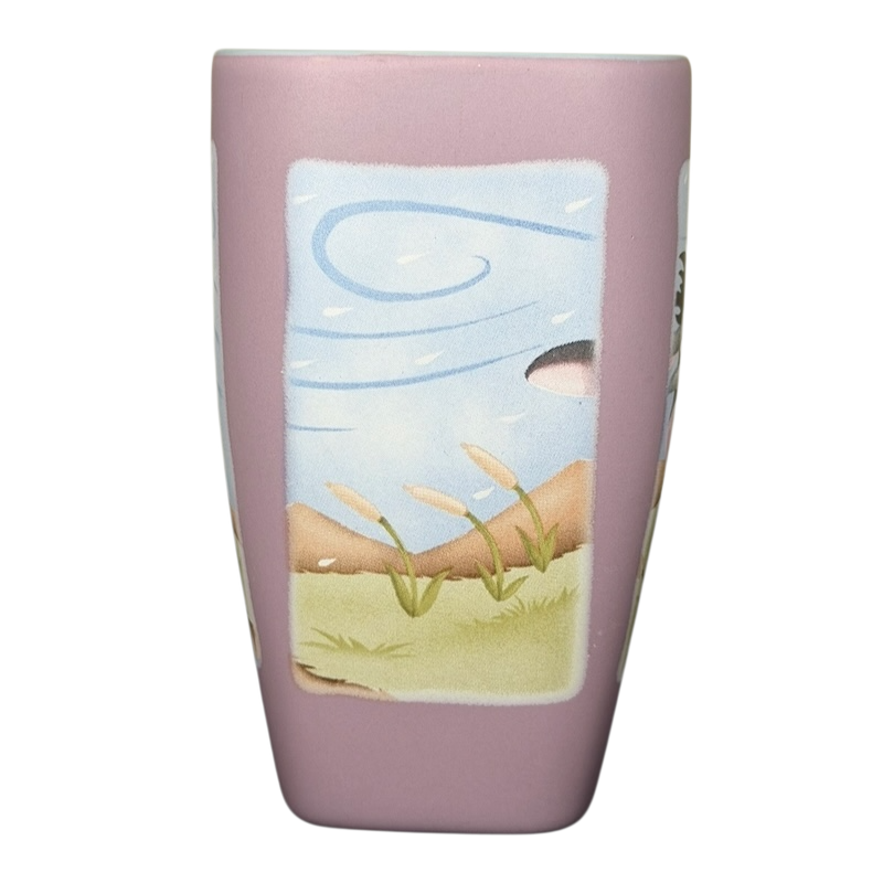 Disneyland Eeyore collectible mug featuring a whimsical landscape design with pastel colors