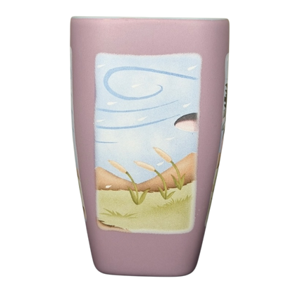 Disneyland Eeyore collectible mug featuring a whimsical landscape design with pastel colors