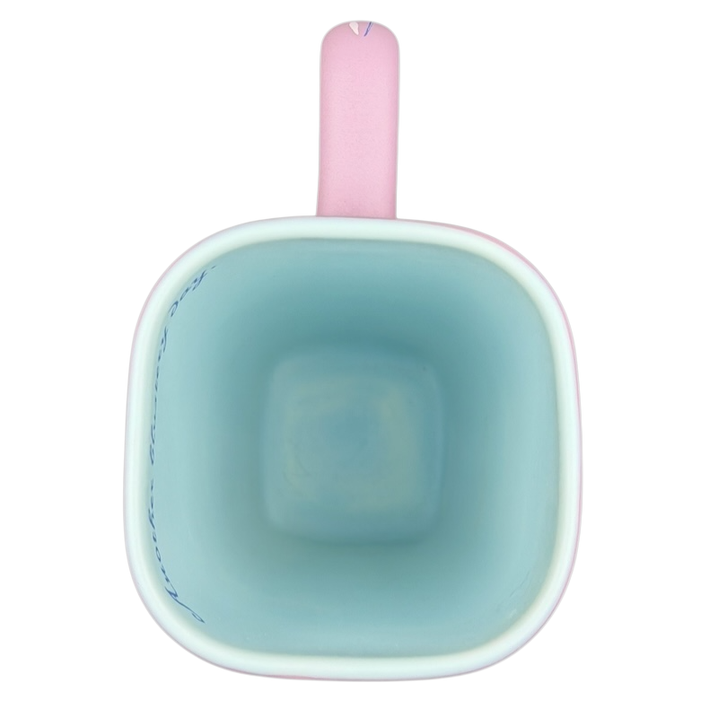 Inside view of Disneyland Eeyore collectible mug featuring a pastel blue interior and pink handle