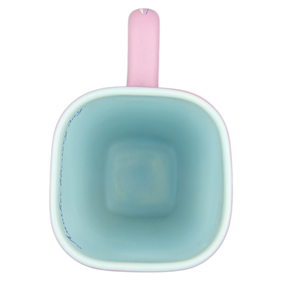 Inside view of Disneyland Eeyore collectible mug featuring a pastel blue interior and pink handle