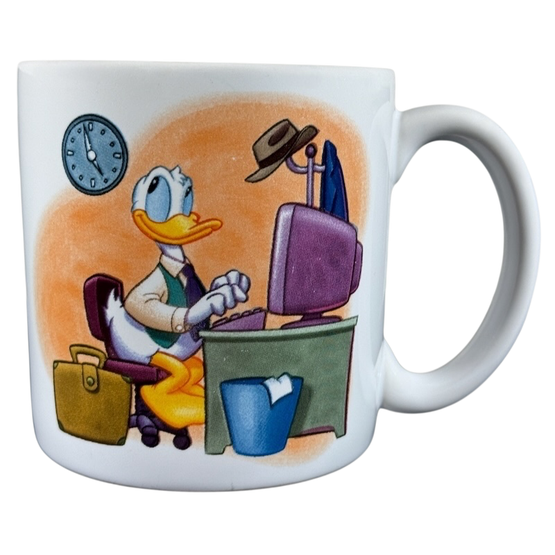 Disney Clock Watcher vintage Donald Duck mug featuring Donald typing at a desk with a clock on the wall