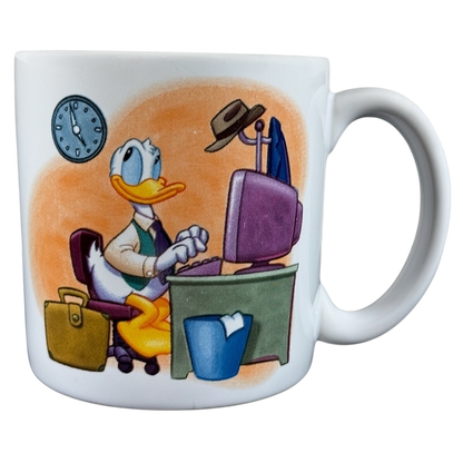Disney Clock Watcher vintage Donald Duck mug featuring Donald typing at a desk with a clock on the wall