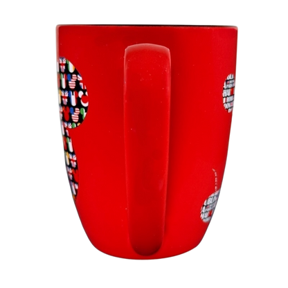 Red Disney Mickey Mouse Magic Around The World vintage mug showing handle and part of colorful Mickey design