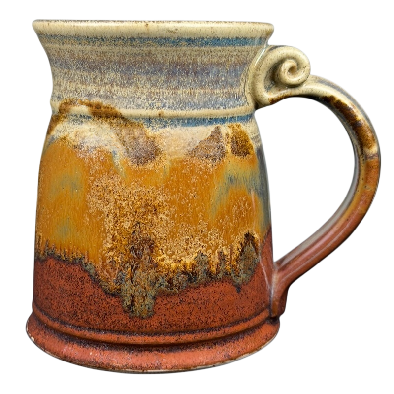 Unique earth-toned handcrafted pottery mug with a rustic design and textured finish