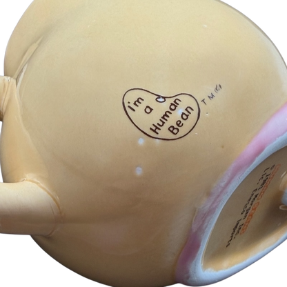 Bottom of Enesco Human Beans Figural Lovable Mug showcasing cute design and heart detail