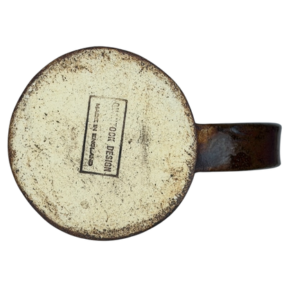 Bottom view of an English Pottery Lion Mug from Quantock Design showcasing its label and rustic finish