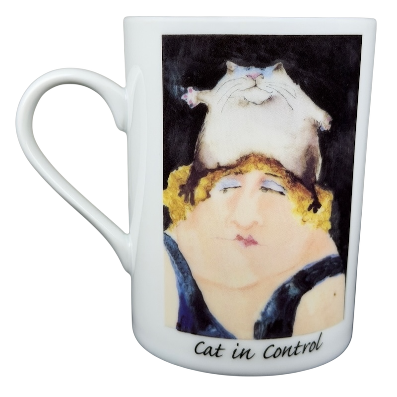 Erika Oller Cat In Control mug featuring a whimsical design of a cat on a woman's head