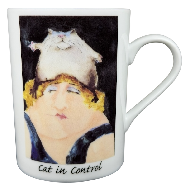 Erika Oller Cat In Control mug featuring a whimsical design of a woman with a cat on her head