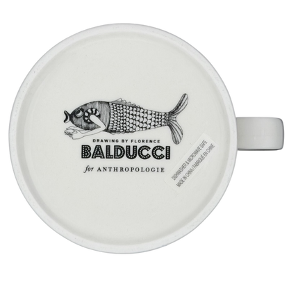 Florence Balducci Cat Monogram Initial Mug Anthropologie with a whimsical fish design on a white ceramic surface