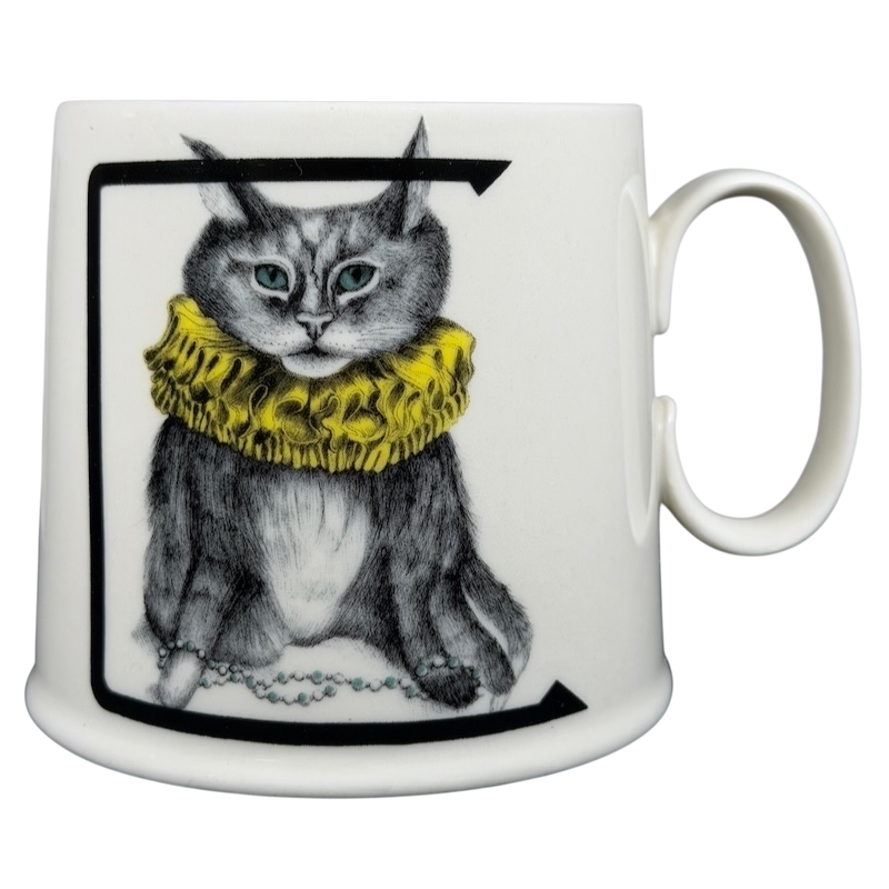 Florence Balducci Cat Monogram Initial Mug Anthropologie featuring a cat with a yellow ruff and blue eyes