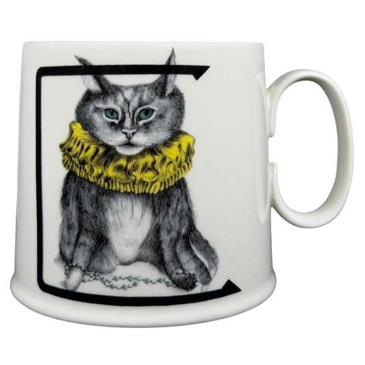 Florence Balducci Cat Monogram Initial Mug Anthropologie featuring a cat with a yellow ruff and blue eyes