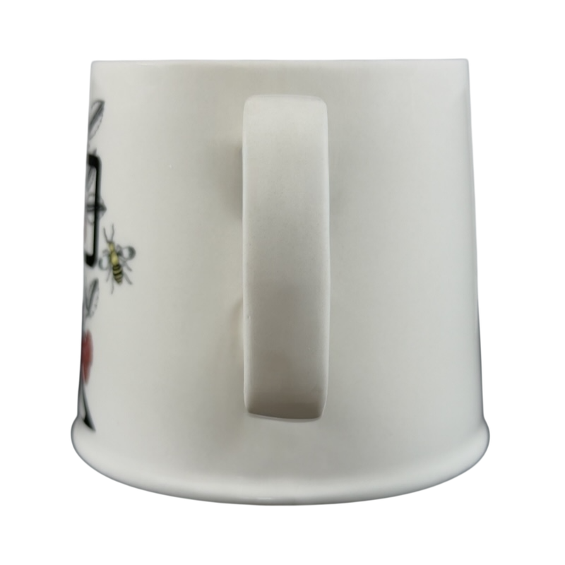 Side view of Florence Balducci monogram mug featuring floral designs and a smooth finish