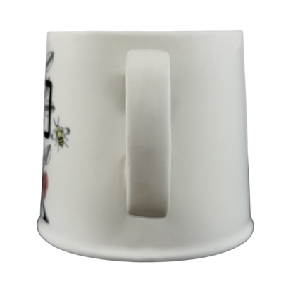 Side view of Florence Balducci monogram mug featuring floral designs and a smooth finish