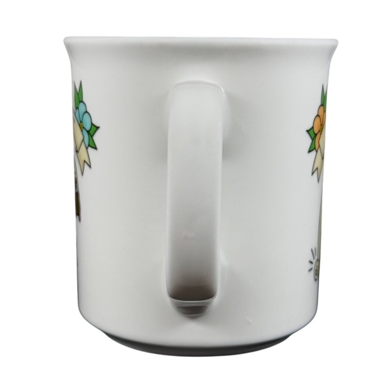 White ceramic draggin vintage pug dog mug with colorful floral design on sides and large handle