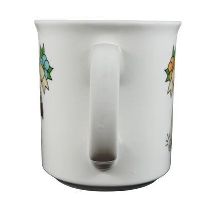 White ceramic draggin vintage pug dog mug with colorful floral design on sides and large handle