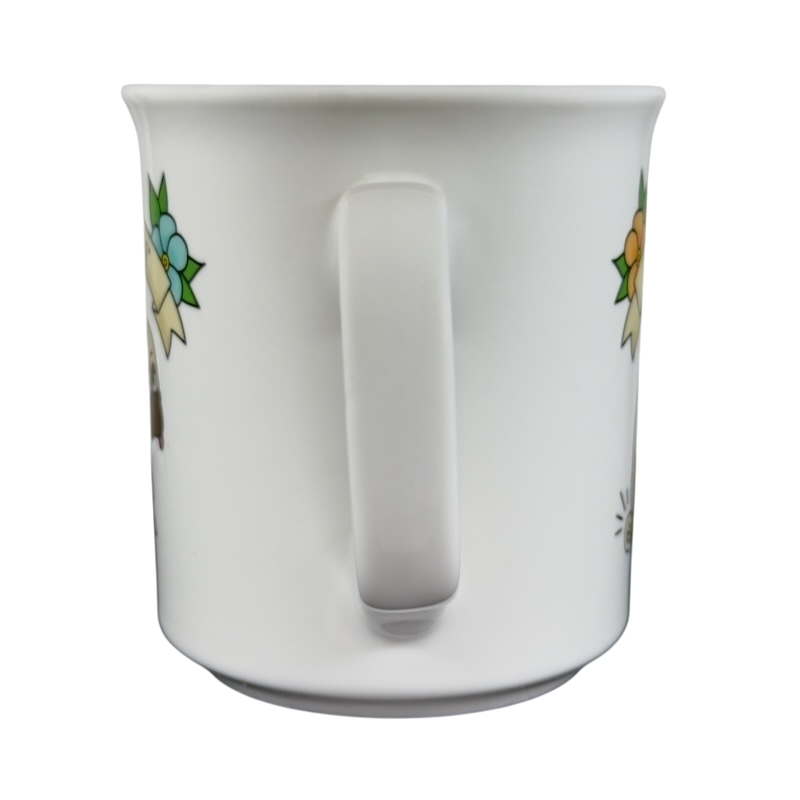 White ceramic draggin vintage pug dog mug with colorful floral designs and a curved handle