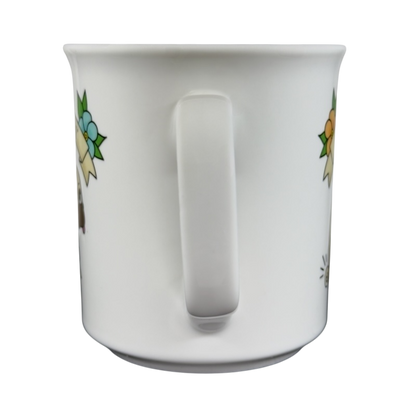 White ceramic draggin vintage pug dog mug with colorful floral designs and a curved handle