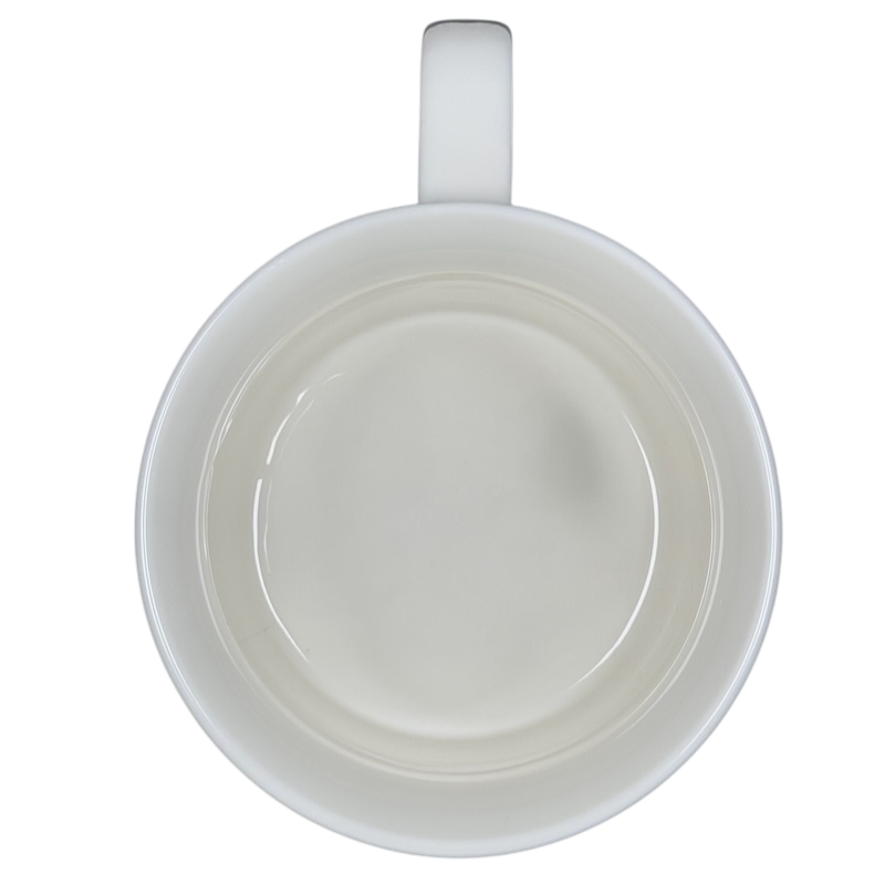 Top view of a white draggin vintage pug dog mug handle visible against black background