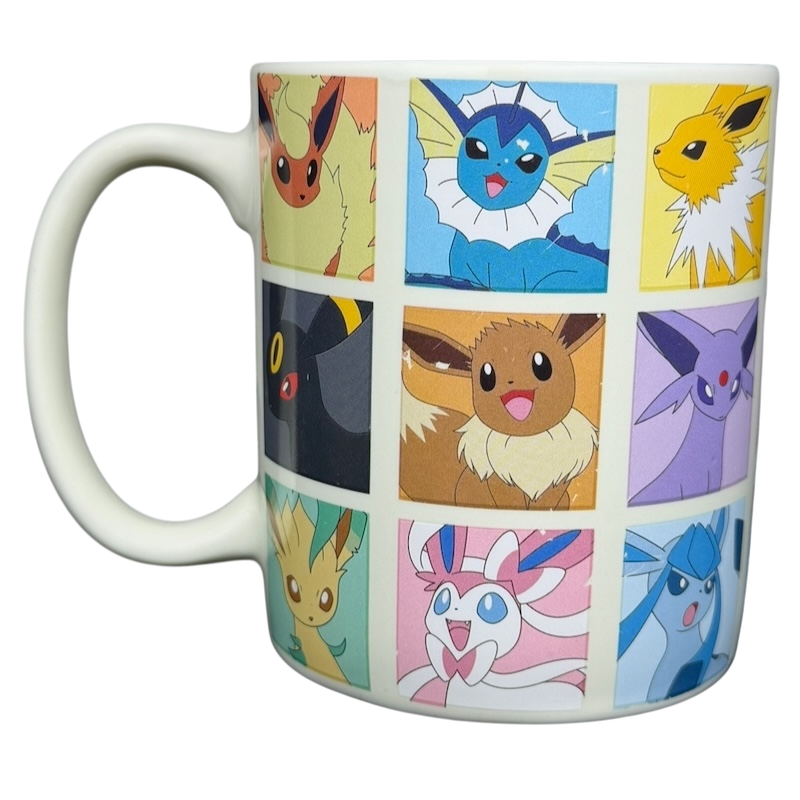 Eevee & Eeveelutions Grid Mug Game Freak featuring vibrant character designs of Eevee and its evolutions