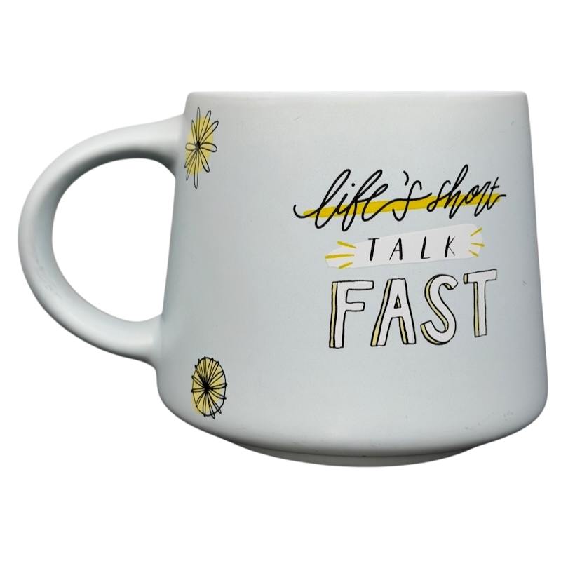 Gilmore Girls Lukes Diner Mug with a white design featuring the phrase life's short talk fast and floral accents