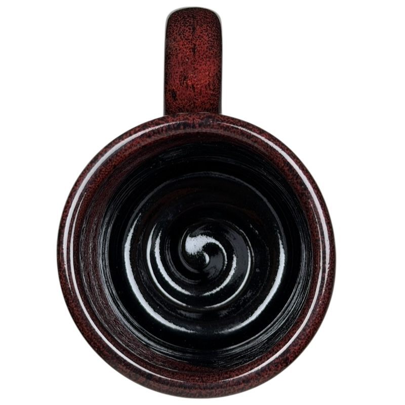 Top view of Grand Canyon Railway Deneen Pottery collectible mug in rich burgundy with a spiral design