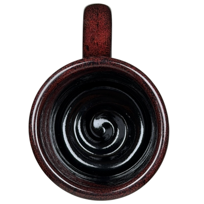 Top view of Grand Canyon Railway Deneen Pottery collectible mug in rich burgundy with a spiral design