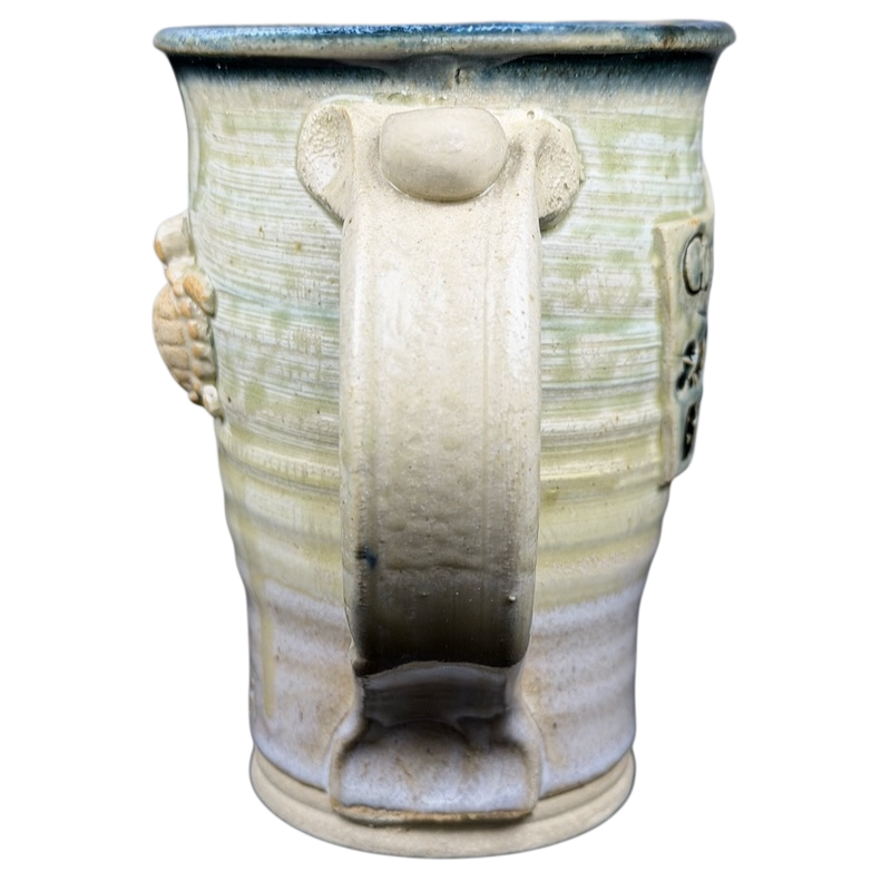 Gulf Shores sea turtle pottery mug featuring a unique design and textured handle for everyday use