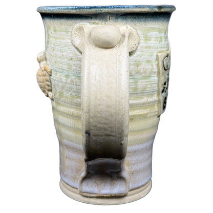 Gulf Shores sea turtle pottery mug featuring a unique design and textured handle for everyday use