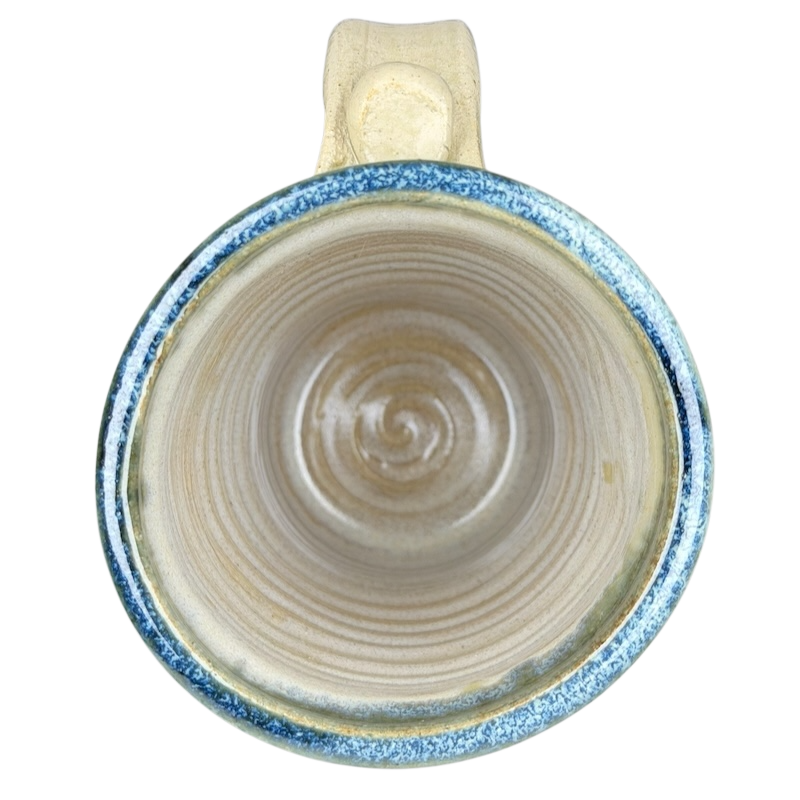 Top view of Gulf Shores sea turtle pottery mug featuring a textured blue rim and natural ceramic interior