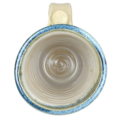 Top view of Gulf Shores sea turtle pottery mug featuring a textured blue rim and natural ceramic interior