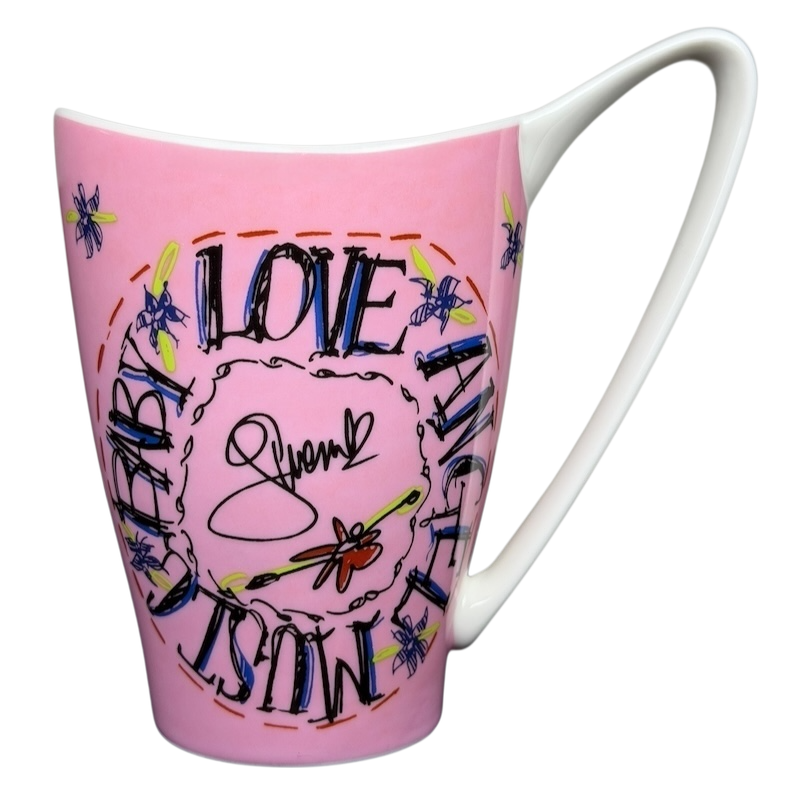 Gwen Stefani collectible mug featuring a pink design with colorful lettering and dragonflies