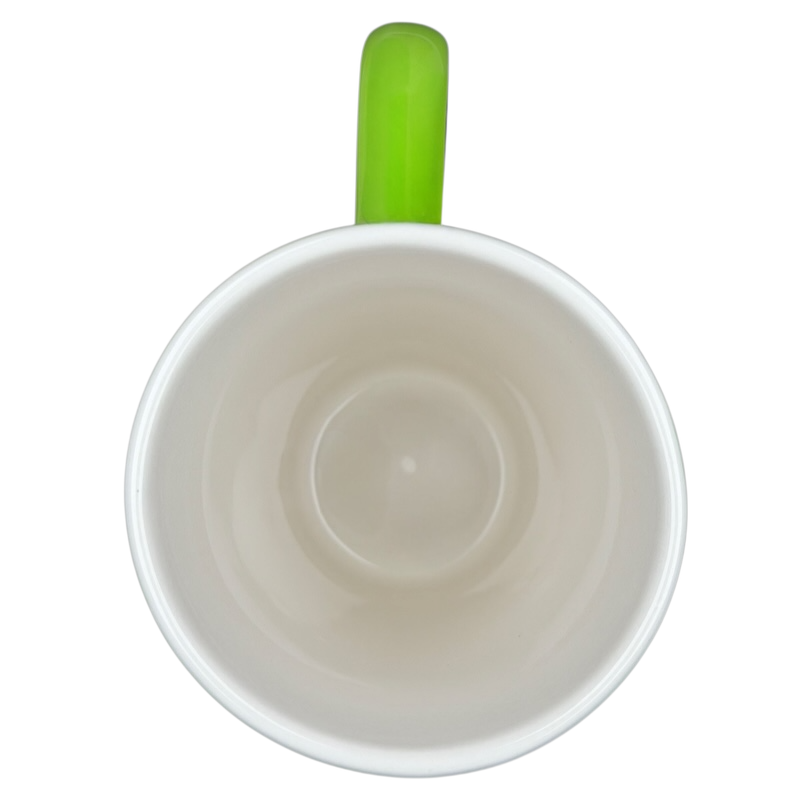 Interior view of the Hallmark Christmas Peace On Earth mug with a vibrant green handle