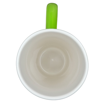 Interior view of the Hallmark Christmas Peace On Earth mug with a vibrant green handle