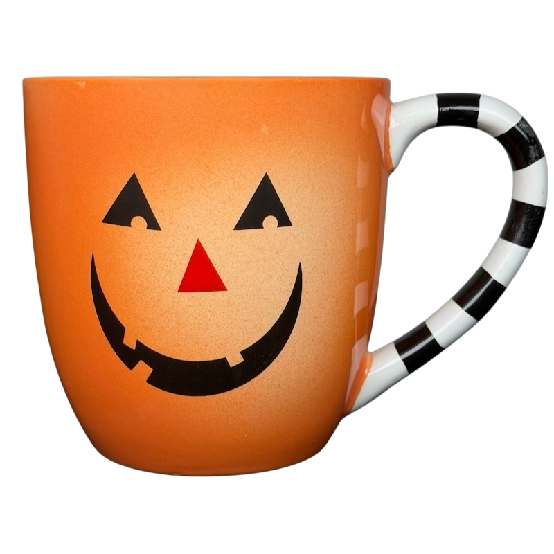 Hallmark Halloween Jack-O'-Lantern vintage mug with a smiling pumpkin face and striped handle
