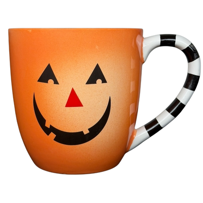 Hallmark Halloween Jack-O'-Lantern vintage mug with a smiling pumpkin face and striped handle